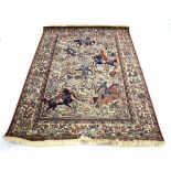 A Louis de Poortere rug depicting a Persian hunting scene in Ispahan,