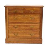 An early 20th century oak chest of two over three drawers on a plinth base,