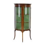 An Edwardian mahogany and strung glazed display cabinet of D-form, on splayed legs, w.