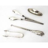 Four early 20th century silver handled dressing table items comprising two button hooks,