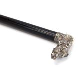 An ebonised walking cane with a Russian silver mounted pommel modelled as a hound,