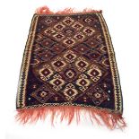 A Turkish kilim, the red and blue ground with four diamonds and dancing motifs,