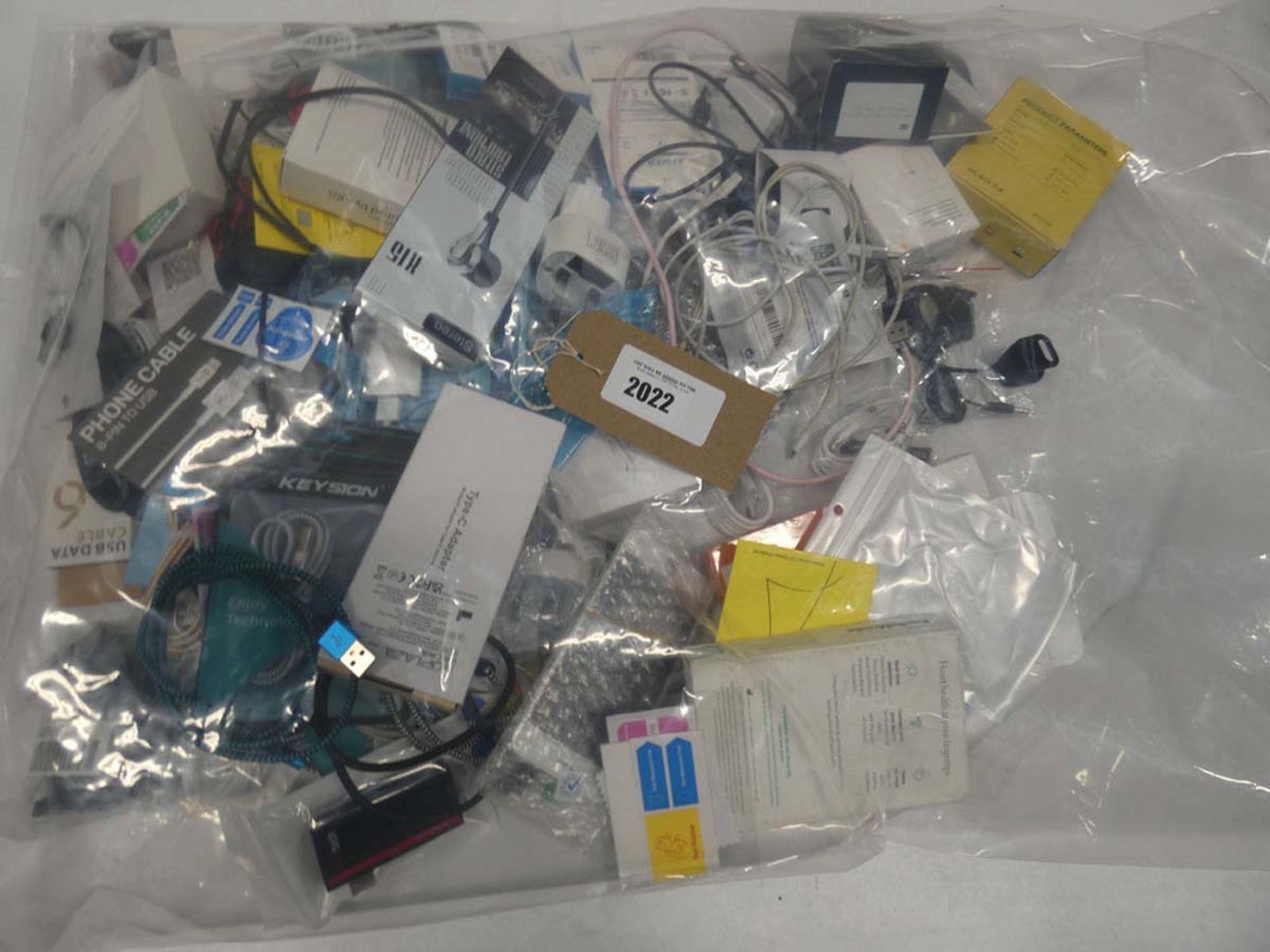 Bag containing quantity of mobile phone accessories; cables, adapters, earphones, etc