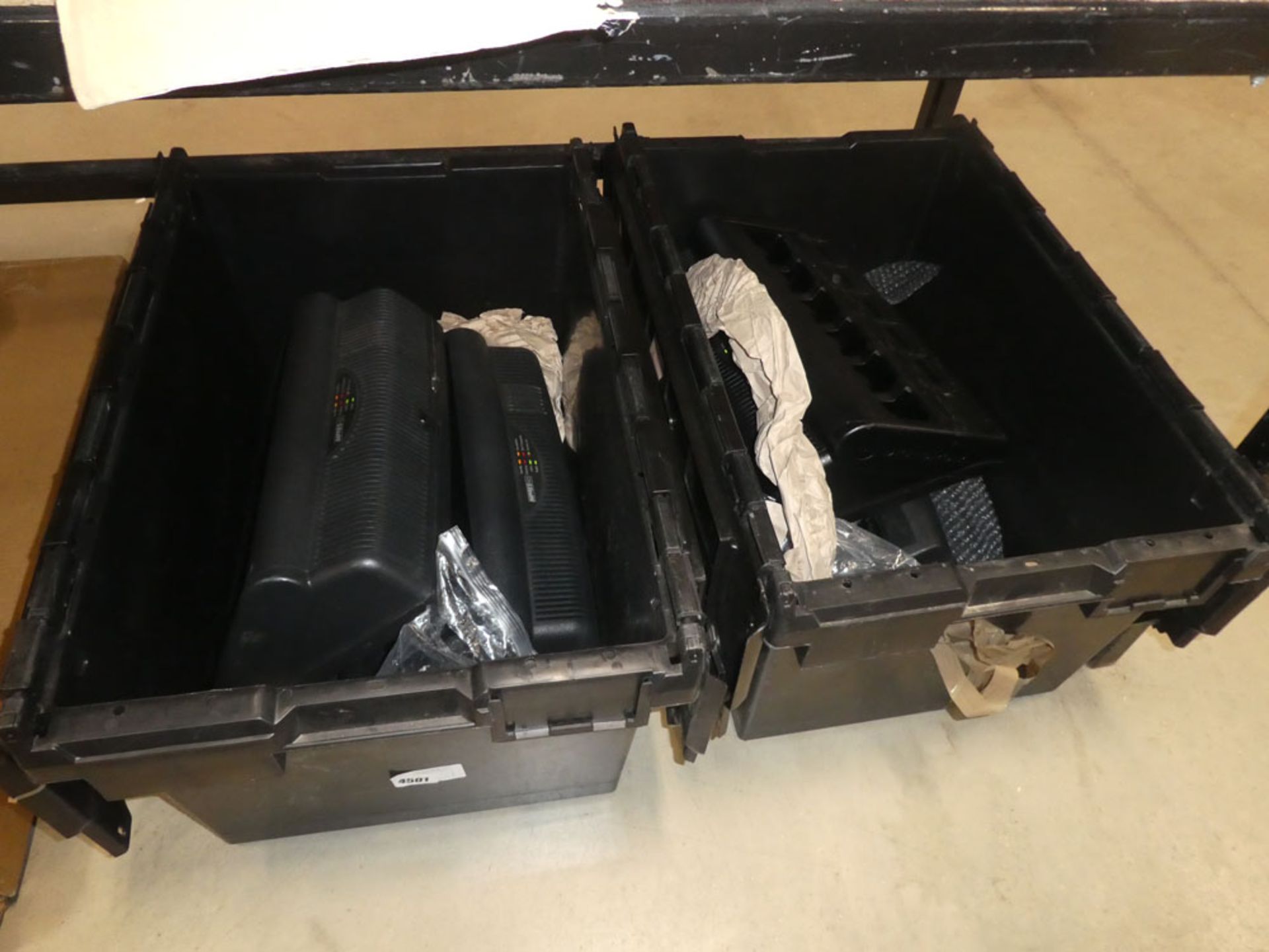 2 plastic crates containing Motorola 2-way radio charging point and batteries, no radios