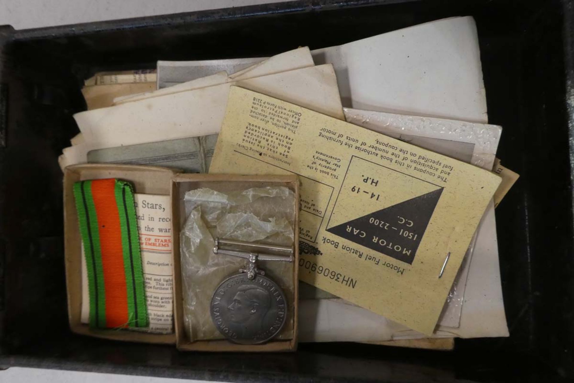 2111 Small steel black tin with medal and photographs