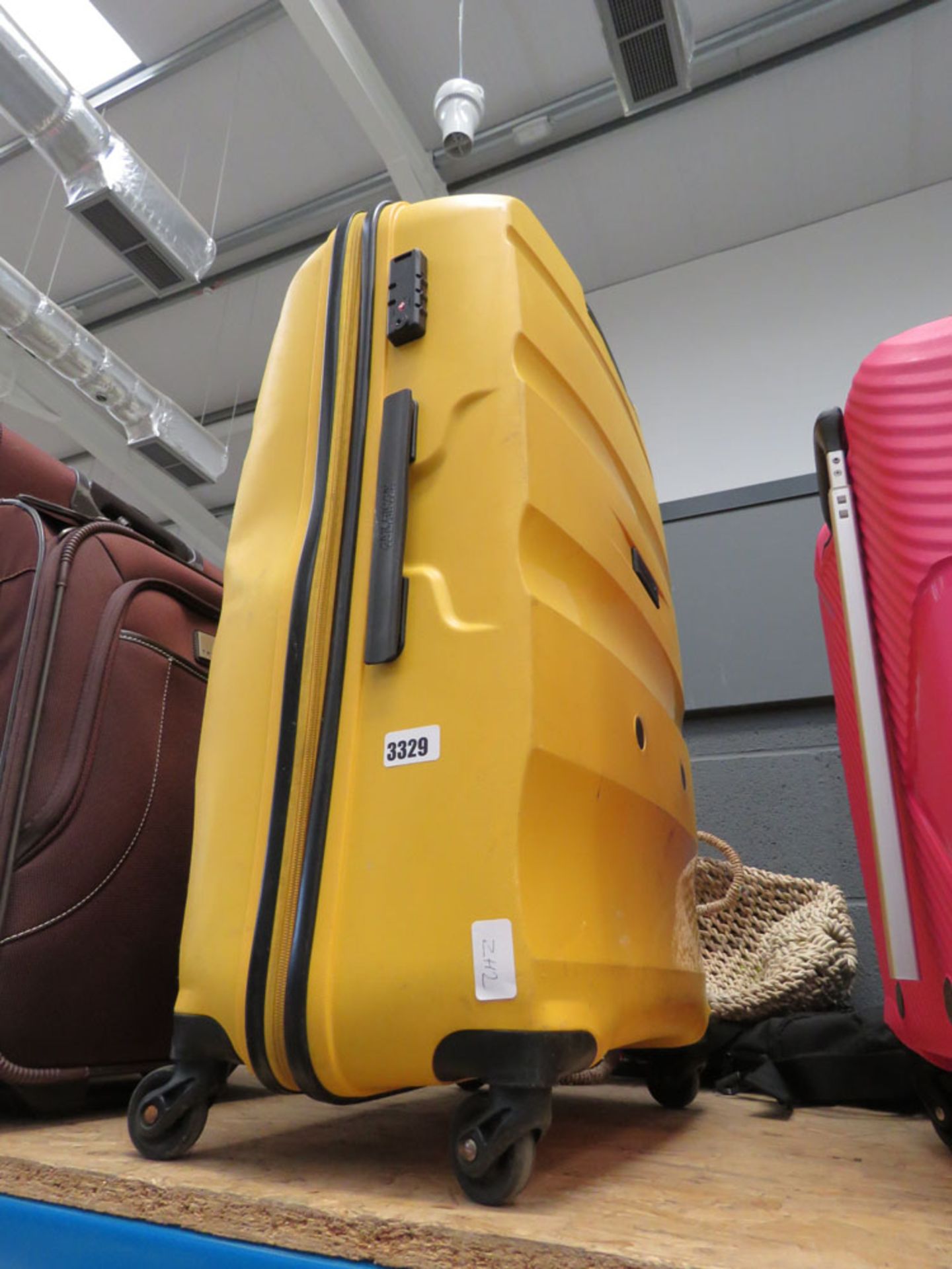 Large hard shelled yellow American Tourister suitcase