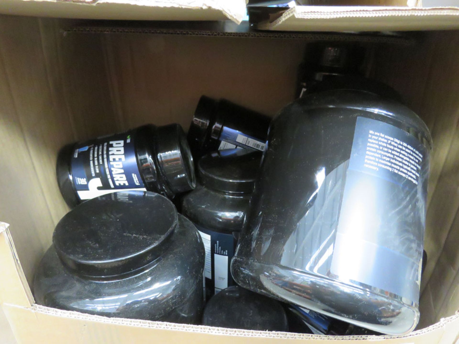 Box containing tubs of JP Way nutritional supplements