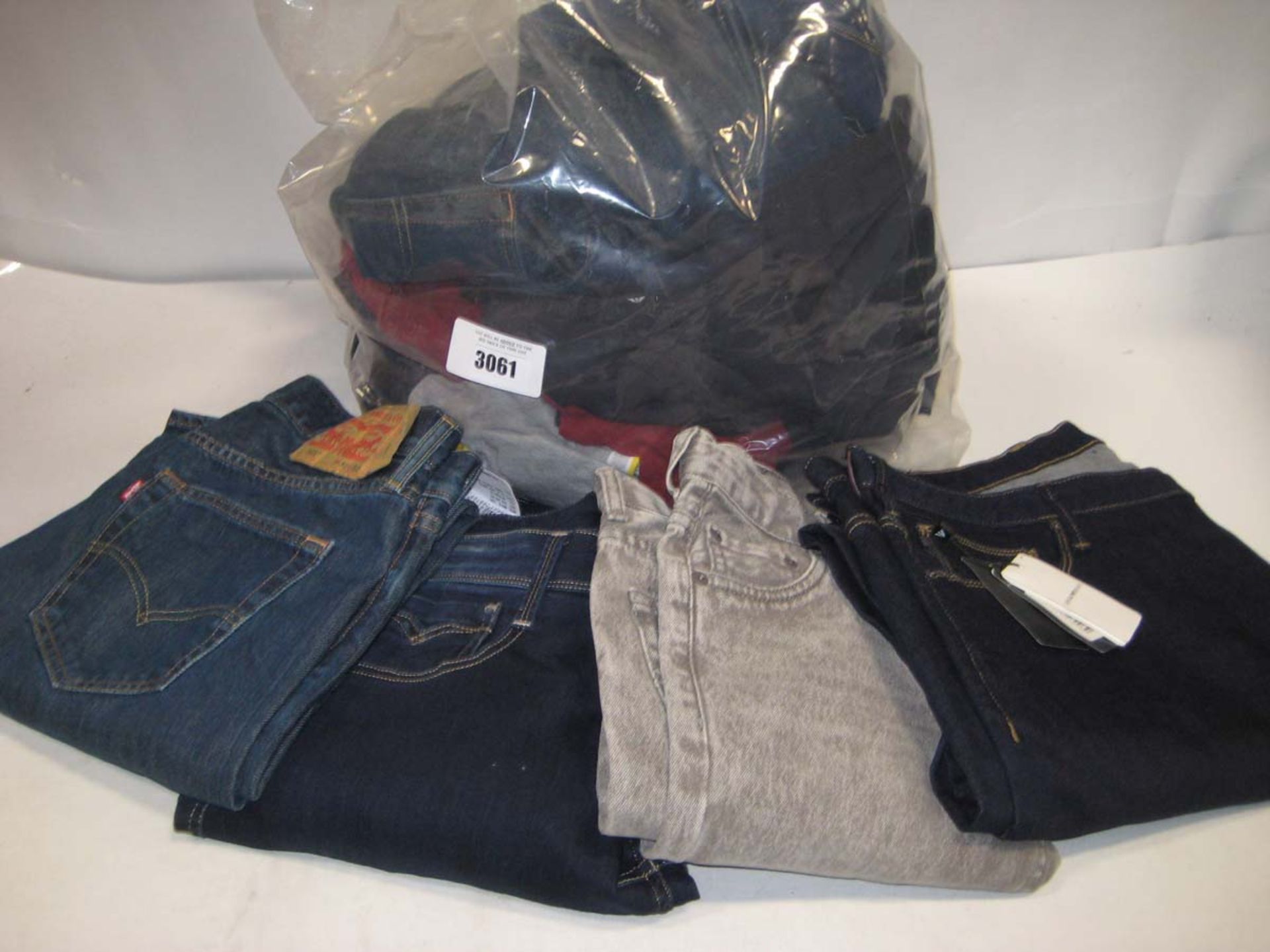 Bag containing Levi jeans, pair of tagged Armani jeans, and pair of untagged chinos, polo shirt by