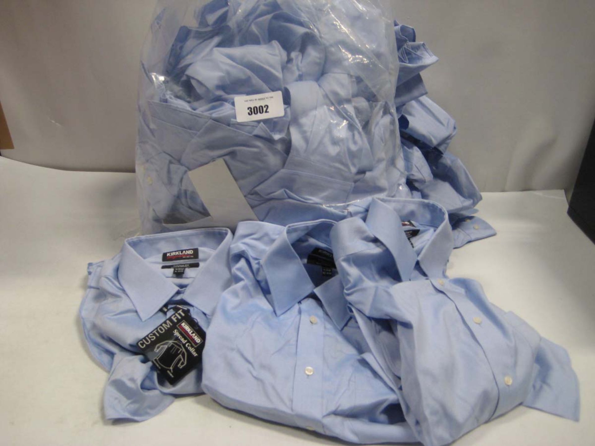 Bag containing Kirkland blue long sleeved shirts, various sizes