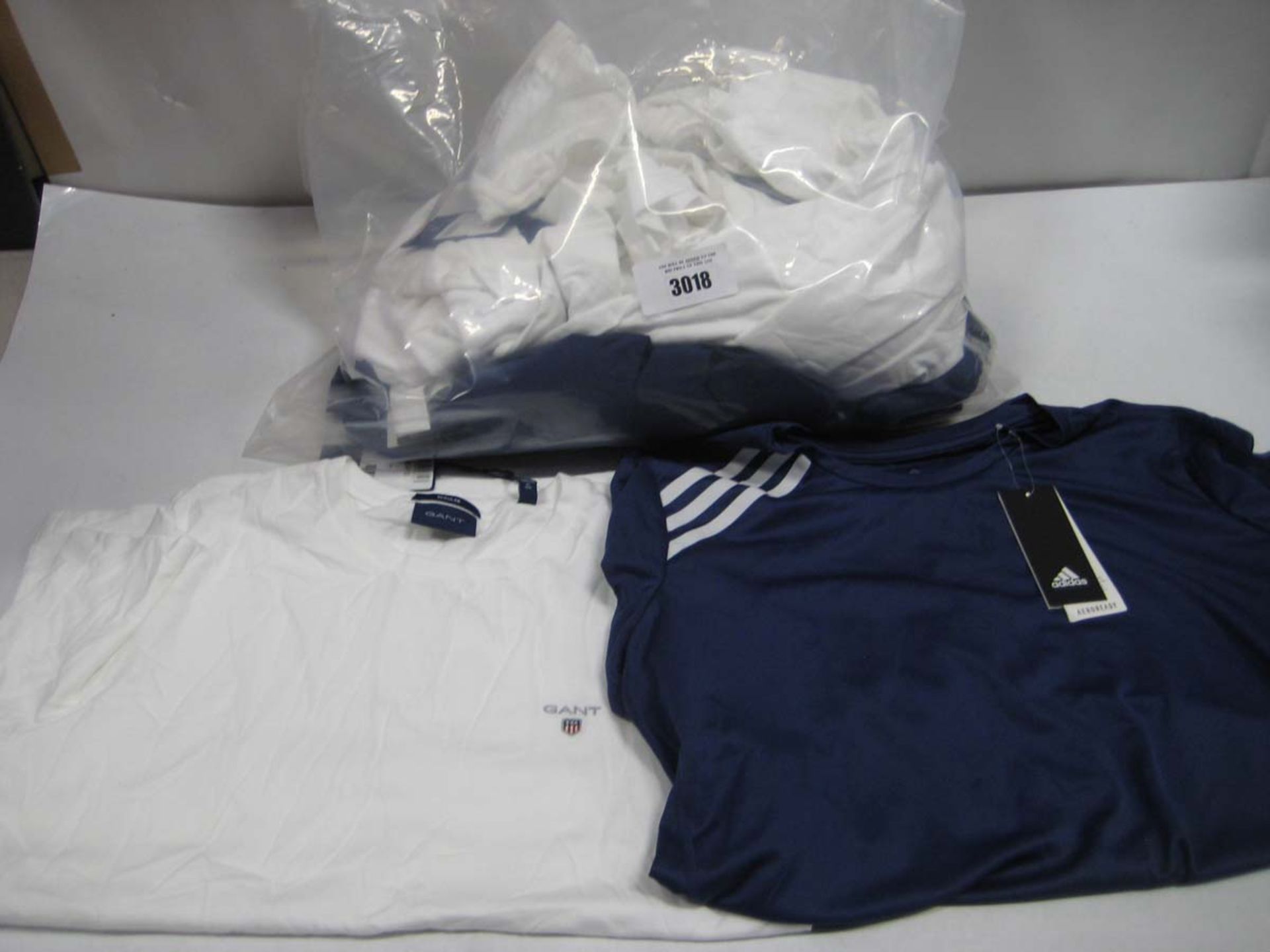 Bag containing small quantity of Gant white t-shirts, Adidas sports tops etc. in blue