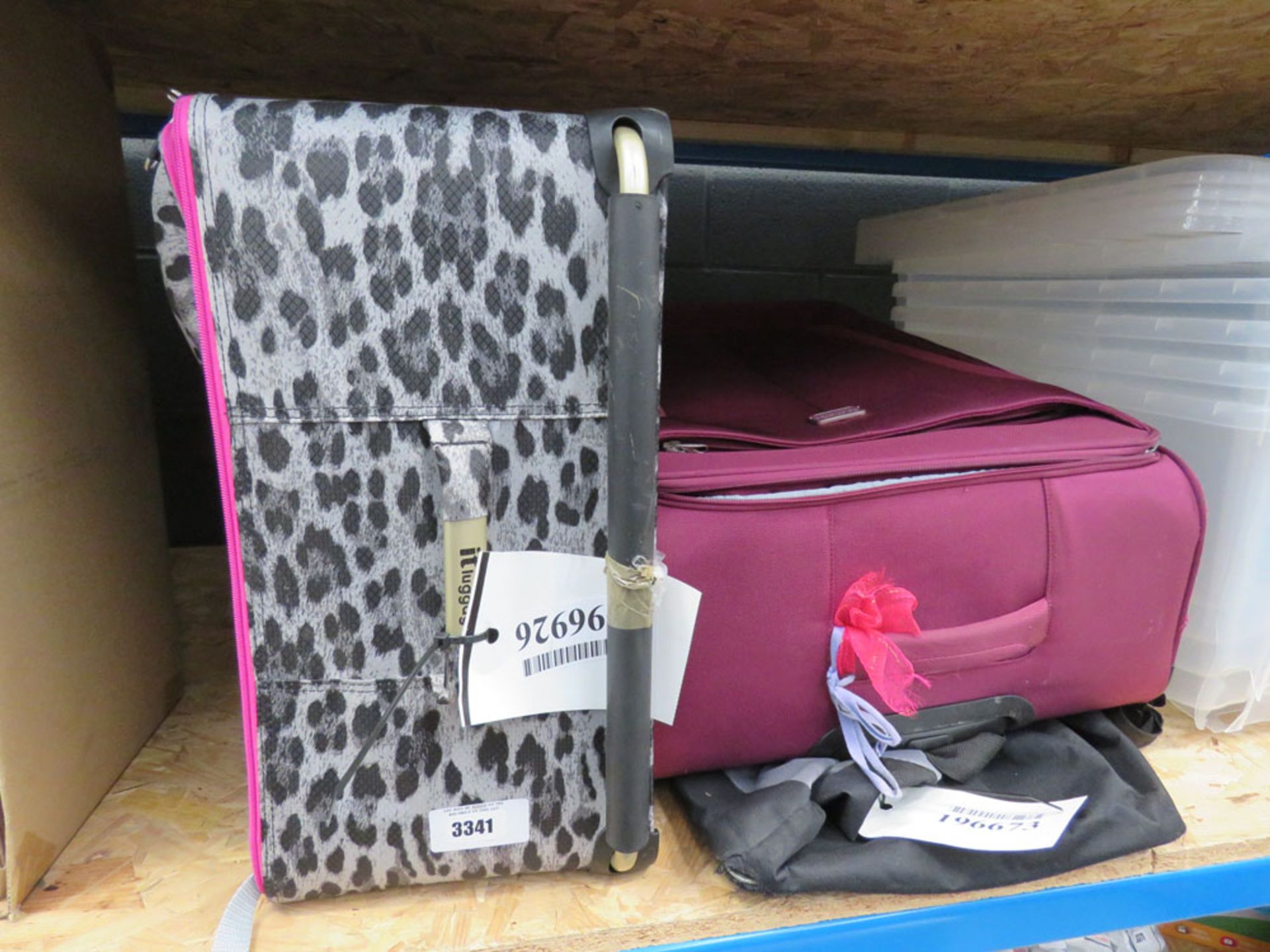 2 mixed size large fabric suitcases