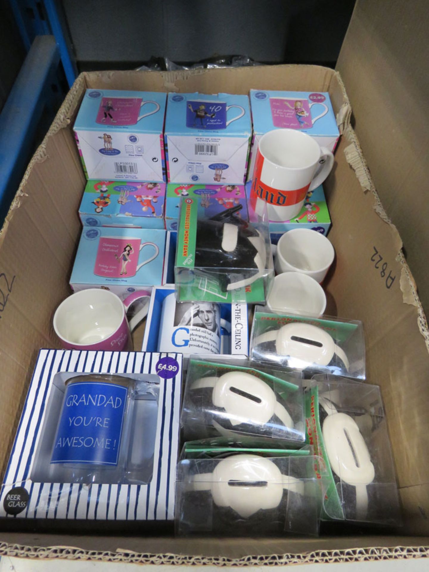 Box containing mugs and money boxes