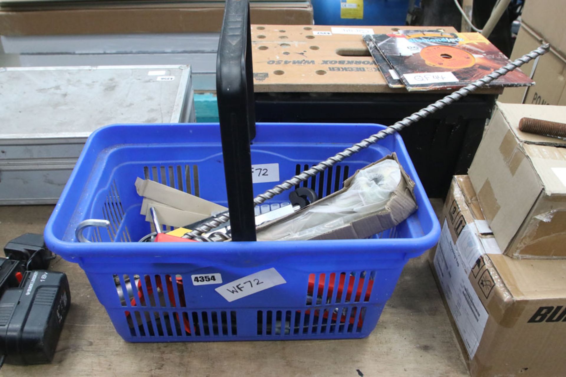 Plastic basket containing various drill bits, gauges, spanners etc