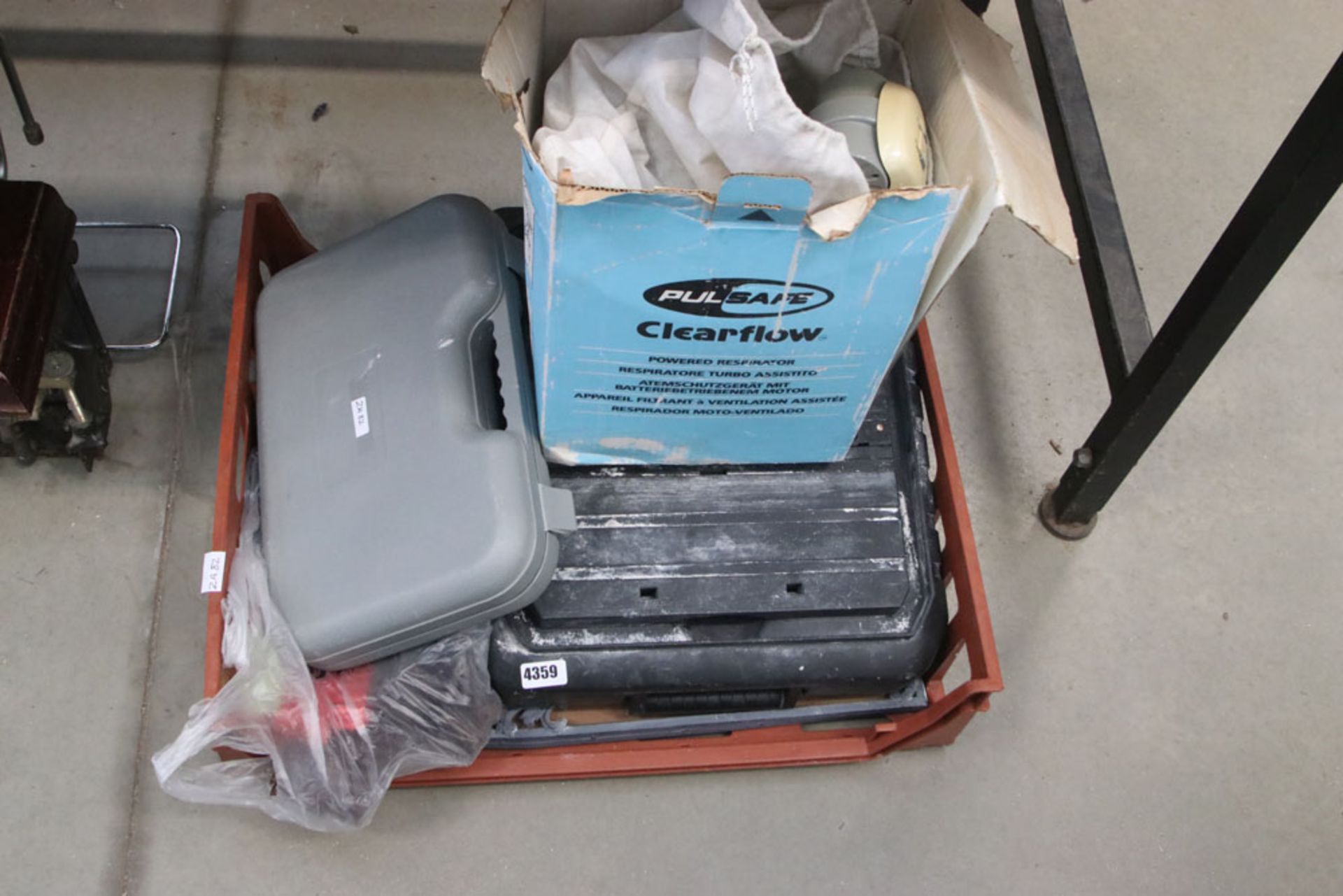Box containing tile cutter, small pipe bender and respirator