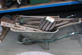 Metal wheelbarrow with a large quantity of garden tools