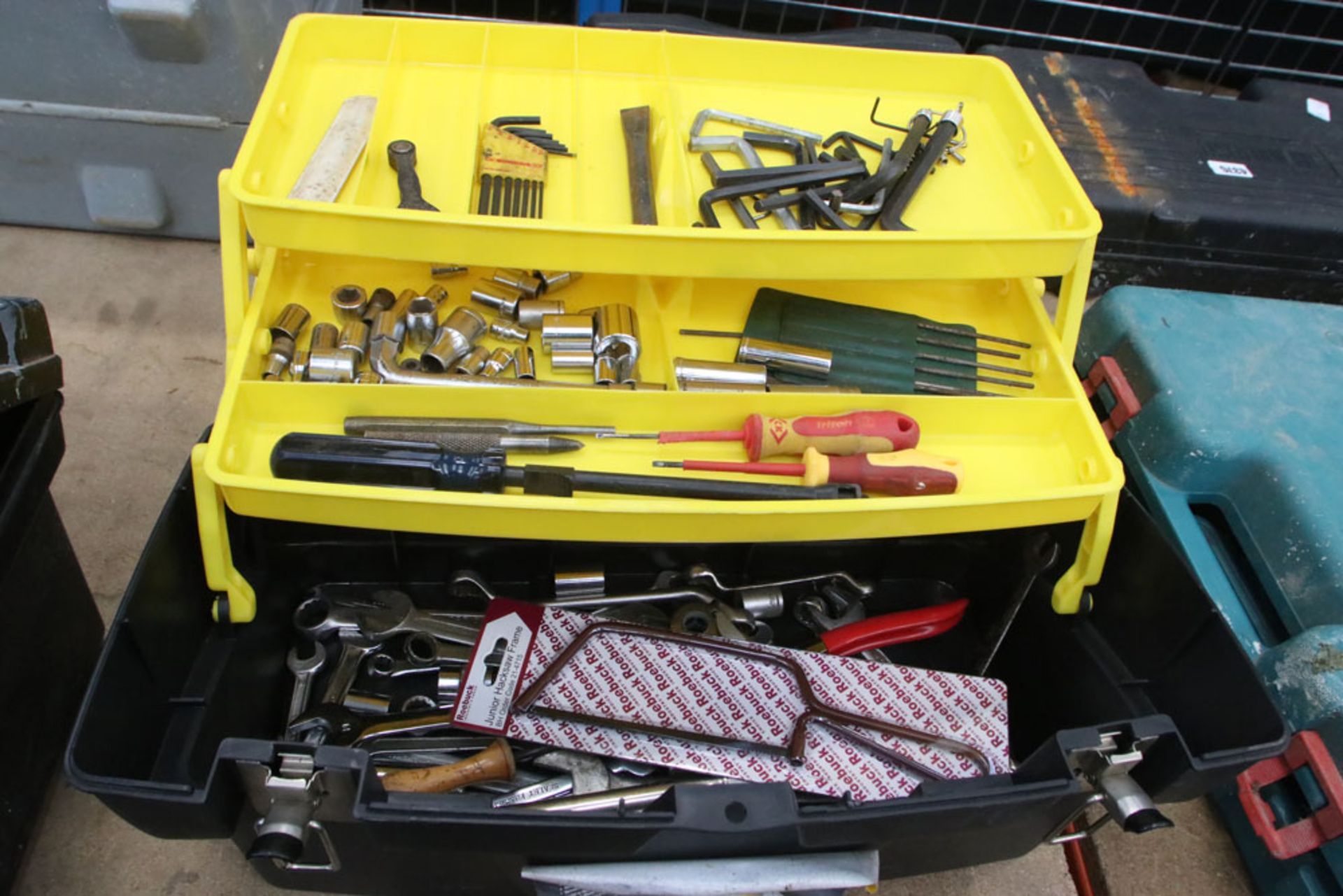 Stanley black and yellow tool box with a small quantity of spanners and allen keys
