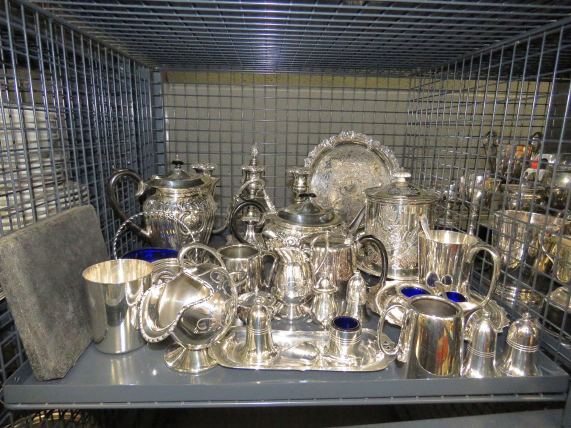 Cage containing a large quantity of silver plate to include biscuit barrel, candlesticks, cruet