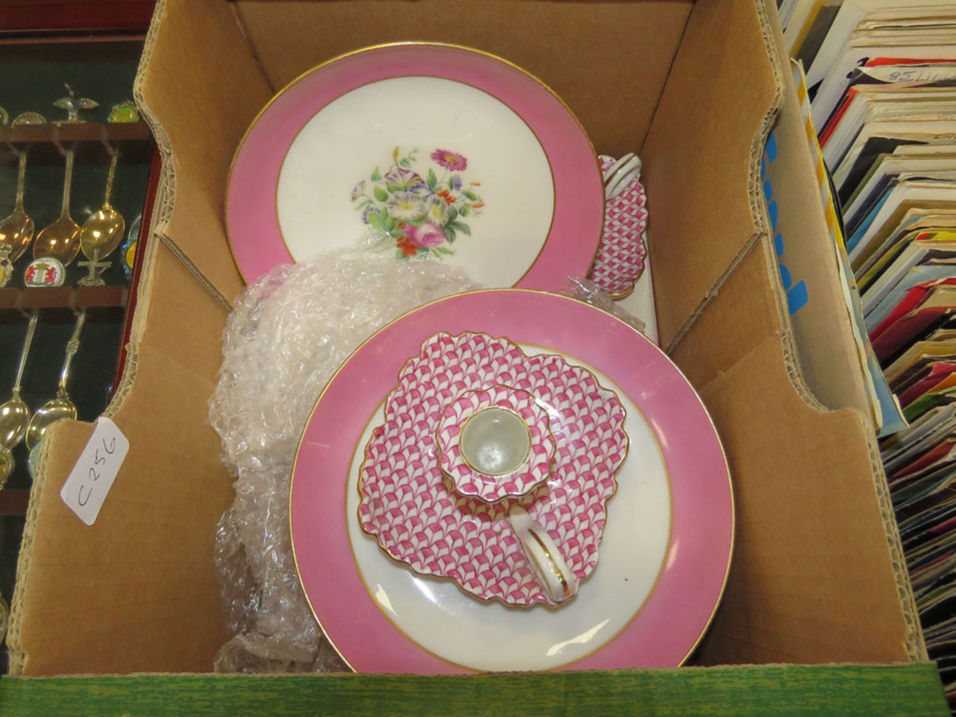 Box containing pink floral glazed bonbon dishes plus a pair of candlesticks