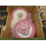 Box containing pink floral glazed bonbon dishes plus a pair of candlesticks