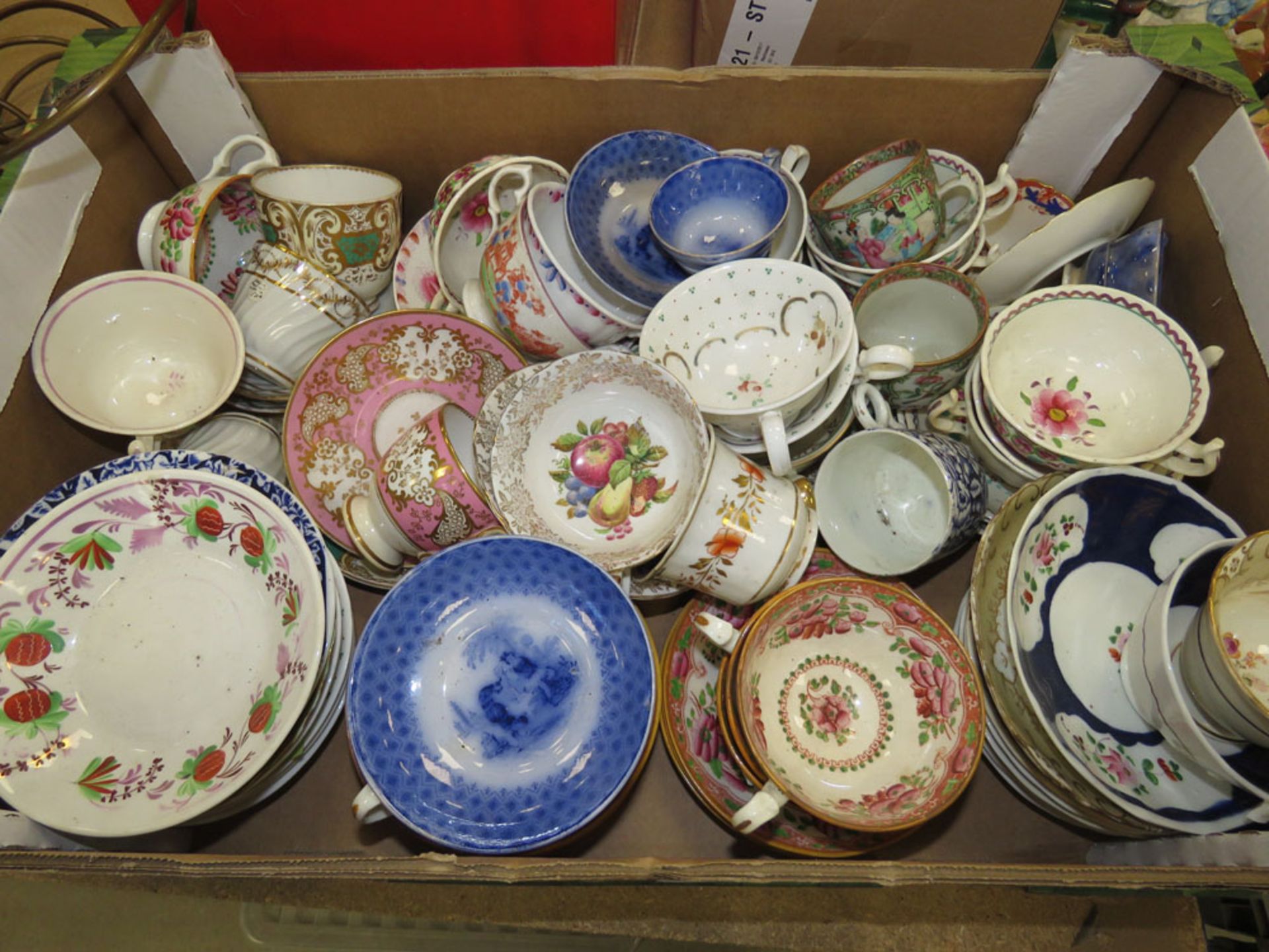 Box containing a large quantity of floral patterned cups and saucers