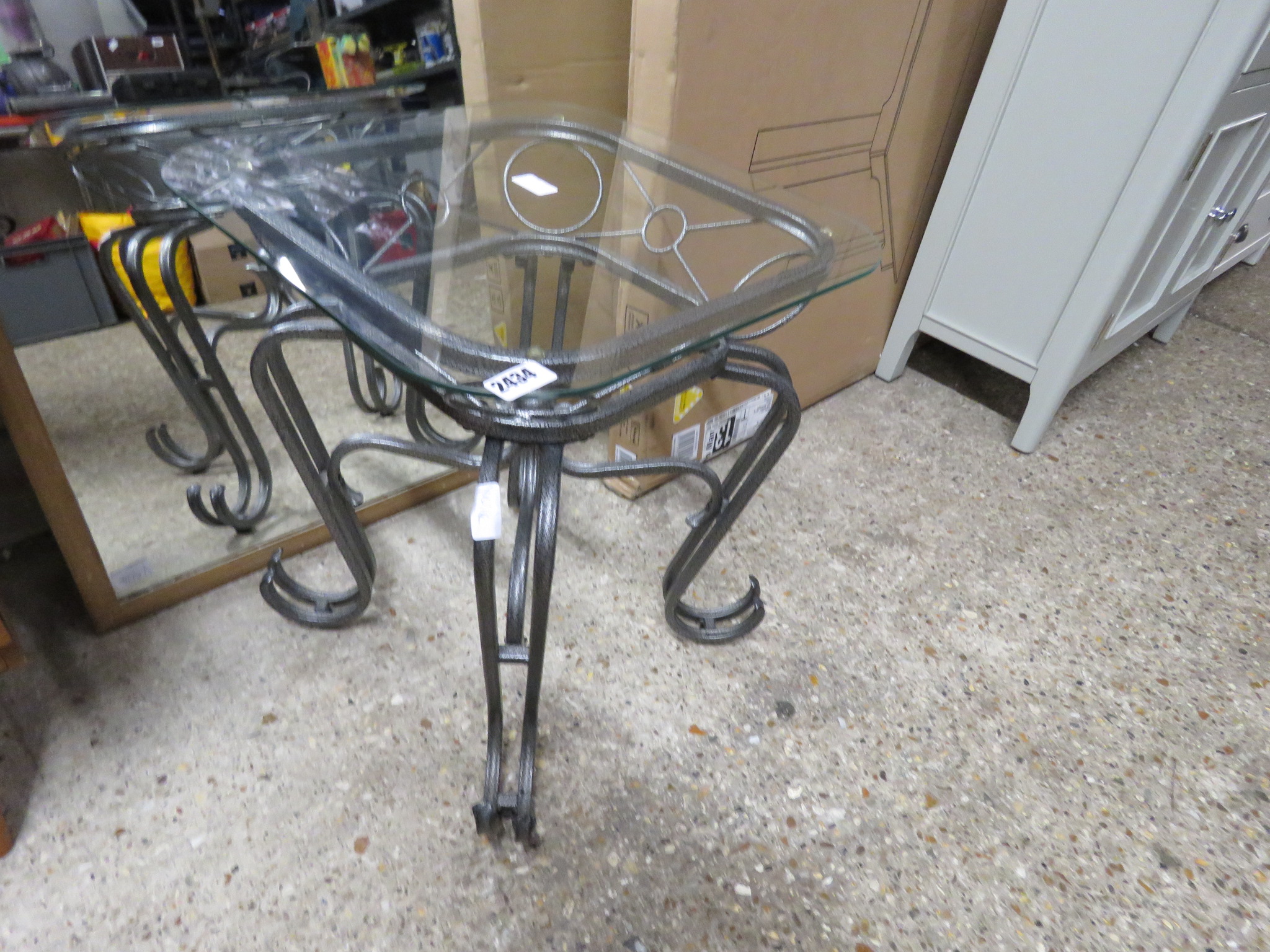 Wrought metal occasional table with glass surface