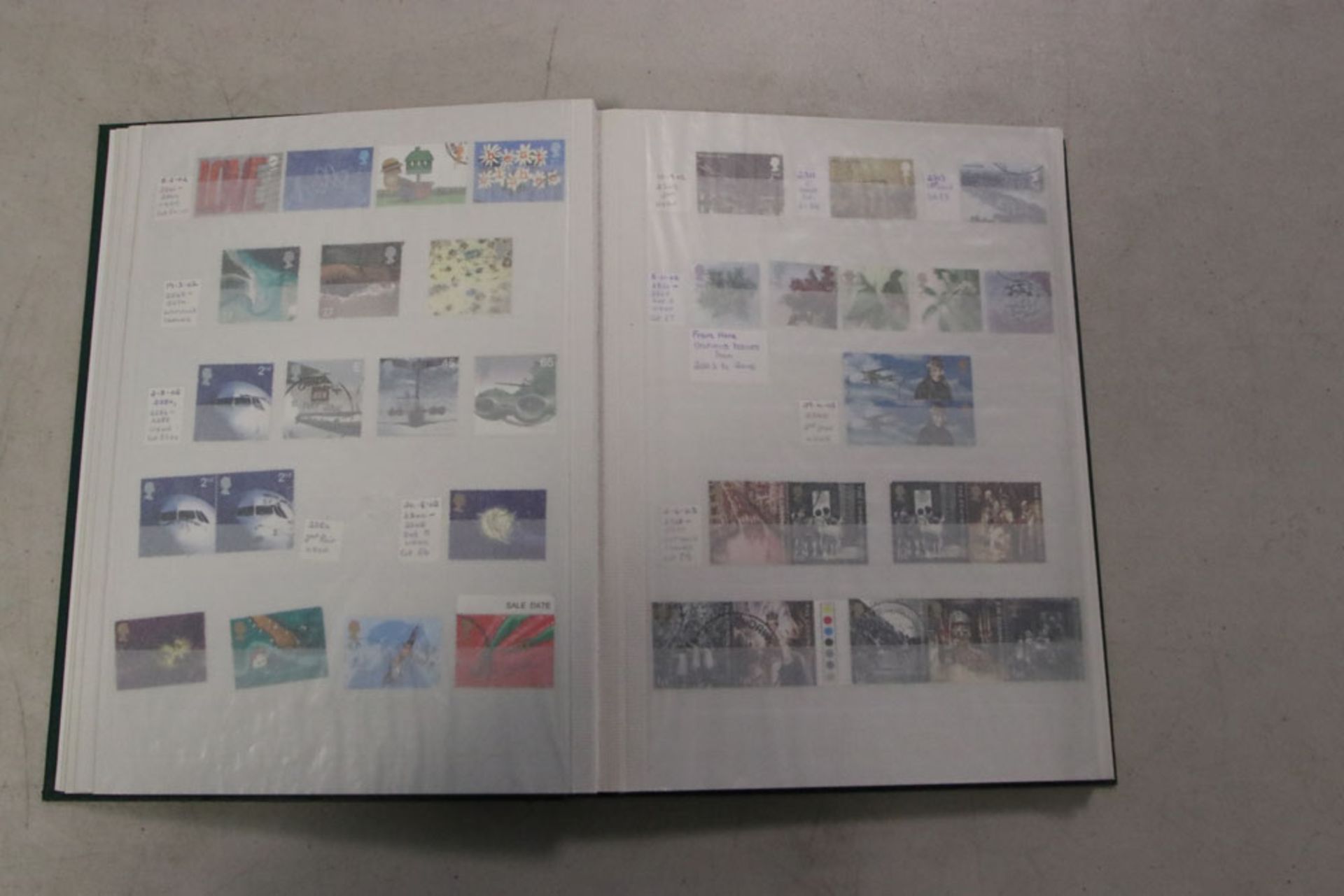 Green stock book with commemorative sets for GB