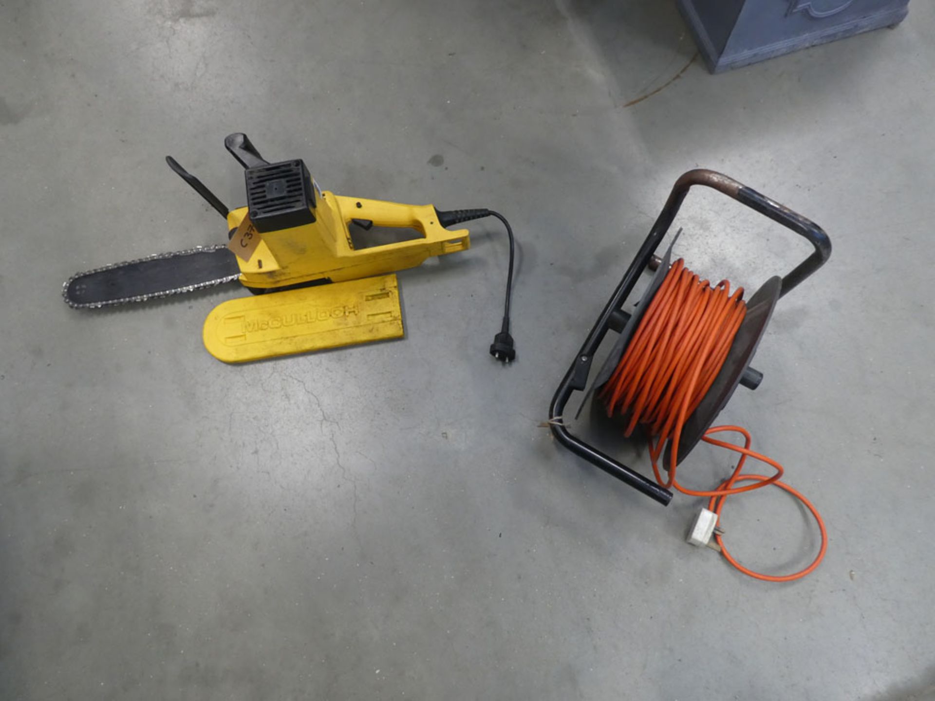 Yellow electric chainsaw with extension cable