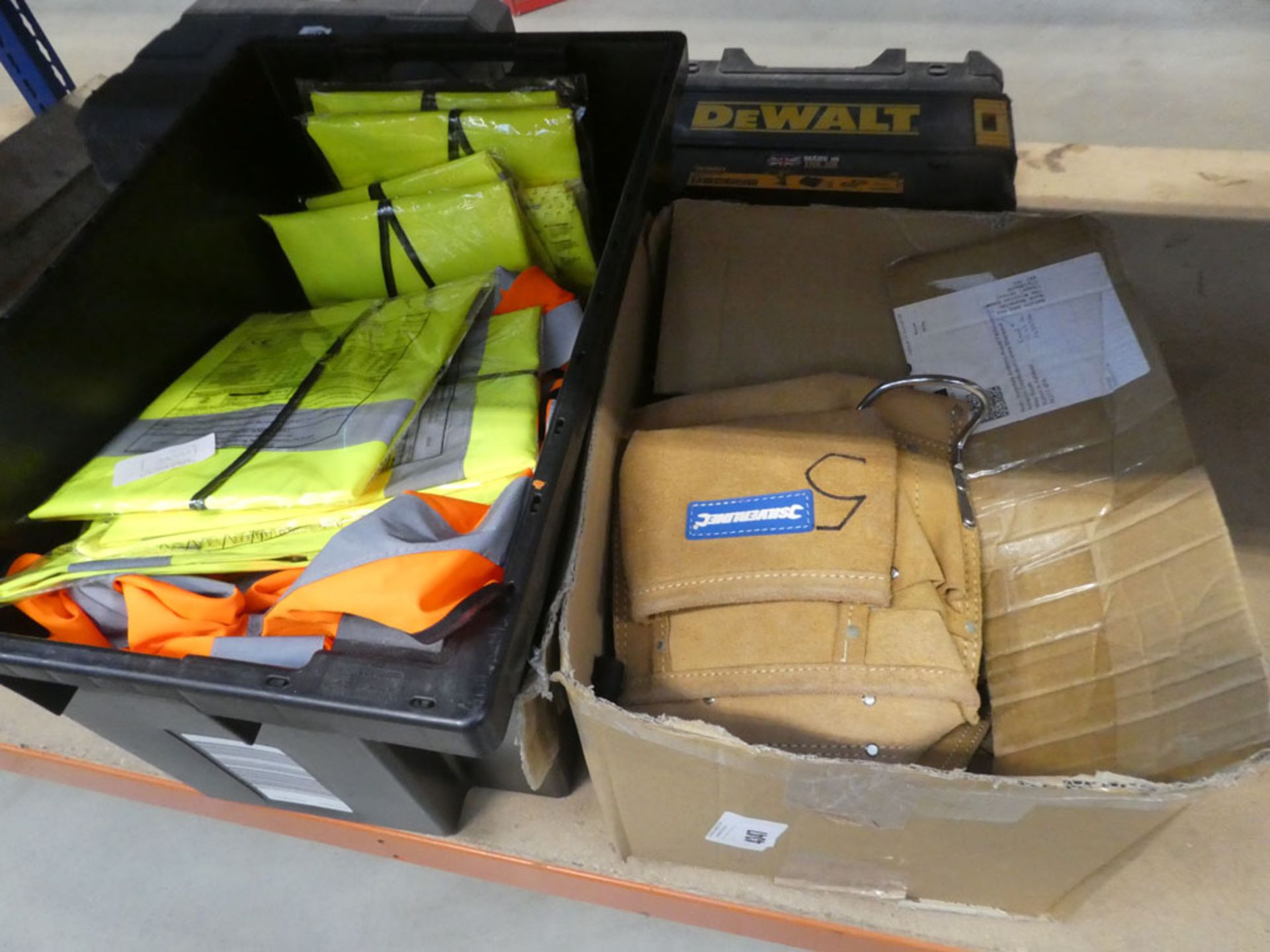 Box of toolbelts and box of fluorescent workwear