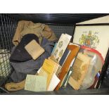 Cage containing military clothing and kit plus first aid handbooks and ephemera