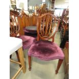 Ten shield back dining chairs with maroon fabric seats
