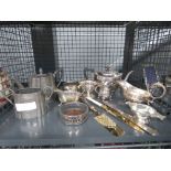 Cage containing silver-plated teapots, sugarbowls, milk jugs and a coaster