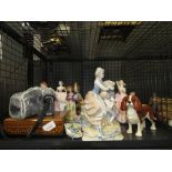 Cage containing Nikon camera, Royal Doulton and other lady figures, ornamental posies and wooden