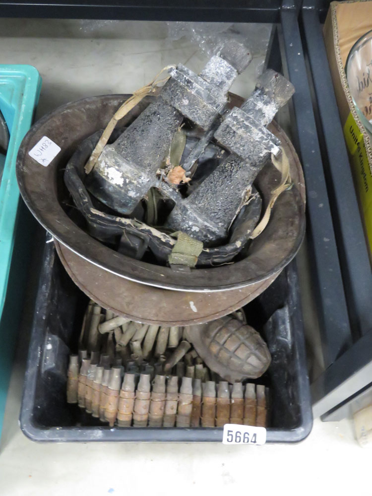 Box containing military helmets, binoculars and cartridges