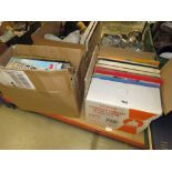 2 boxes and stack of vinyl records
