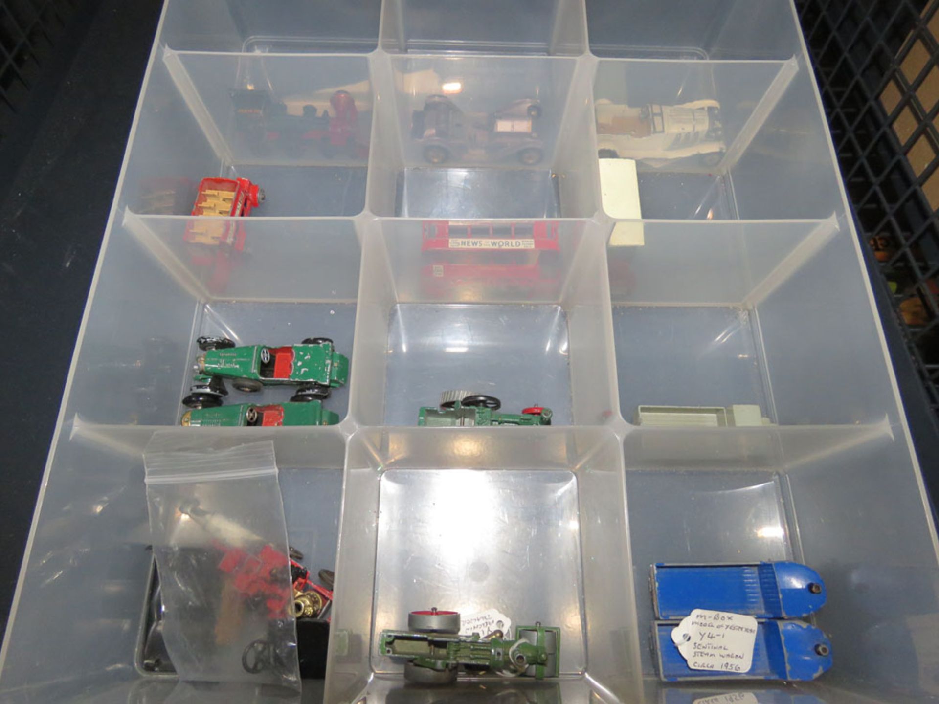Cage containing die-cast cars, buses and tractors