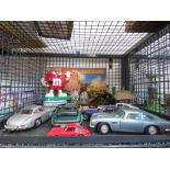 Cage containing die cast cars, rolling stock, Hornby railway magazines, and M&M figure, vintage