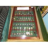 Cabinet with quantity of souvenir spoons