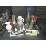 Cage containing a razor blade, opera glasses, camera lens, glass bottles, bells and an ale mug