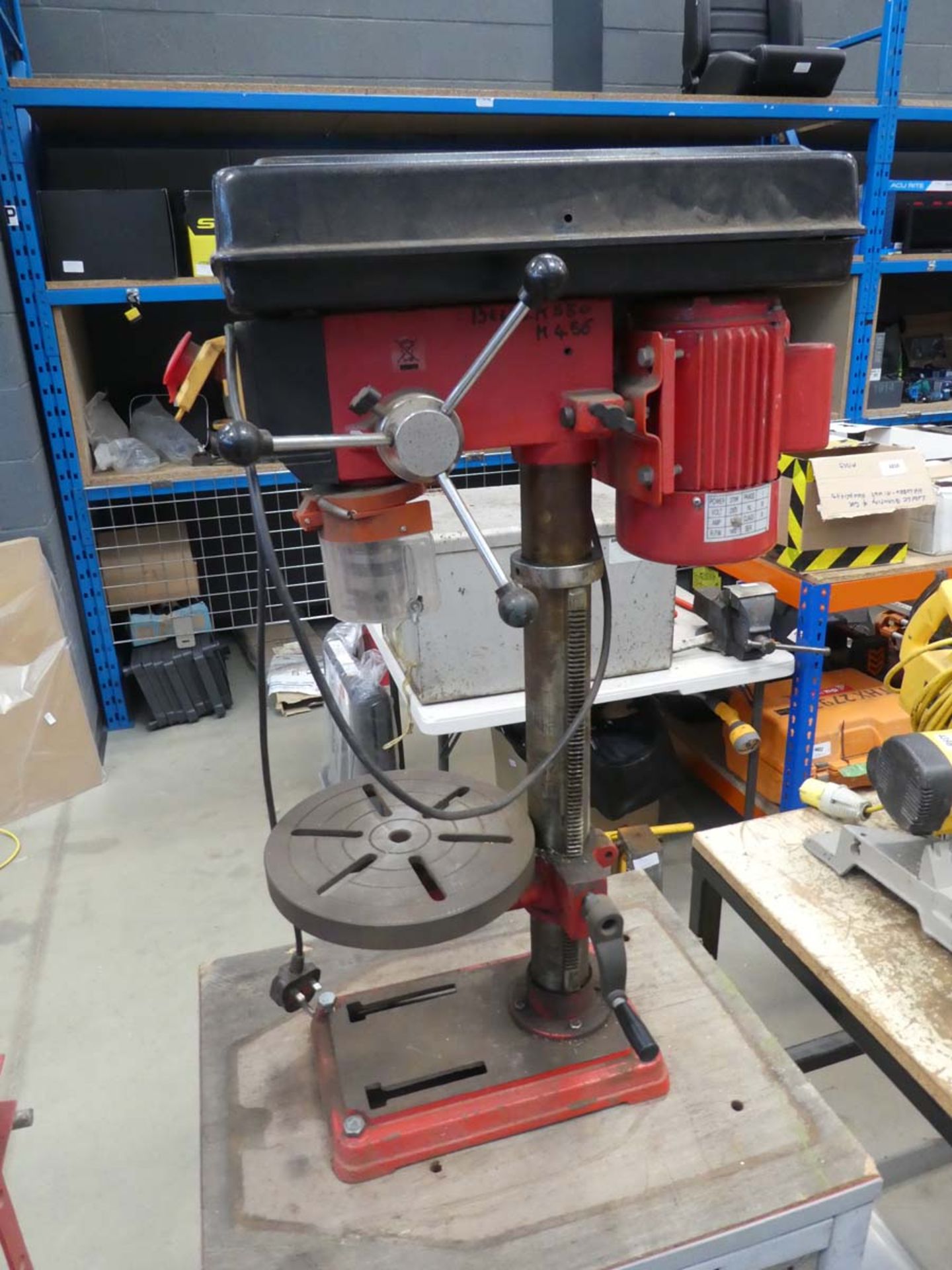 Red pillar drill on stand