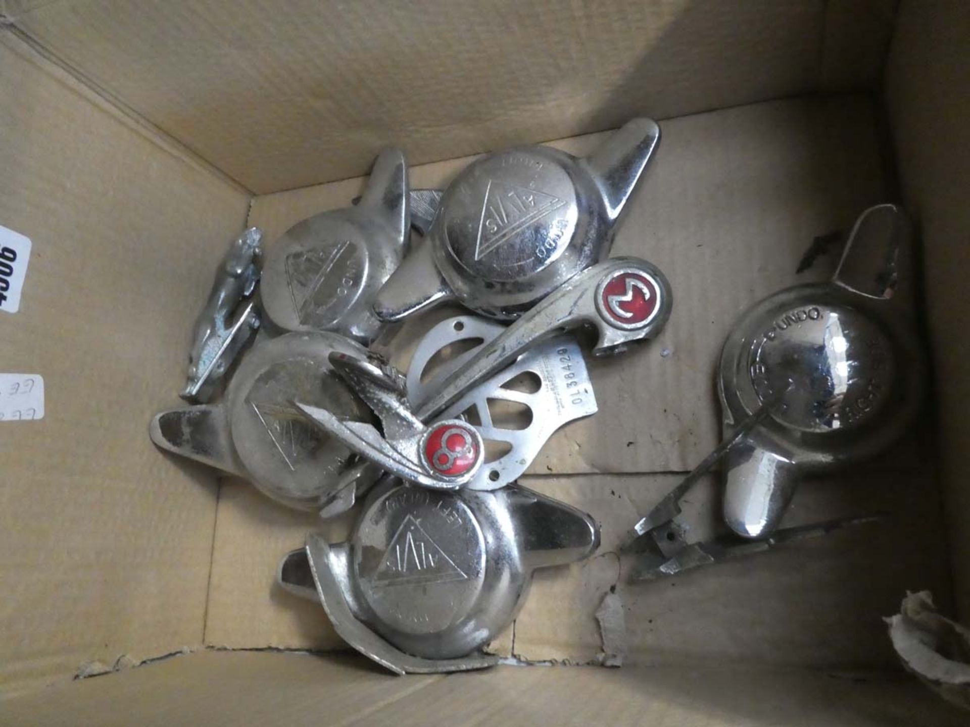 Box of vintage Alvis wheel hubs, AA badges, Jaguar bullet badge and various other vintage car parts