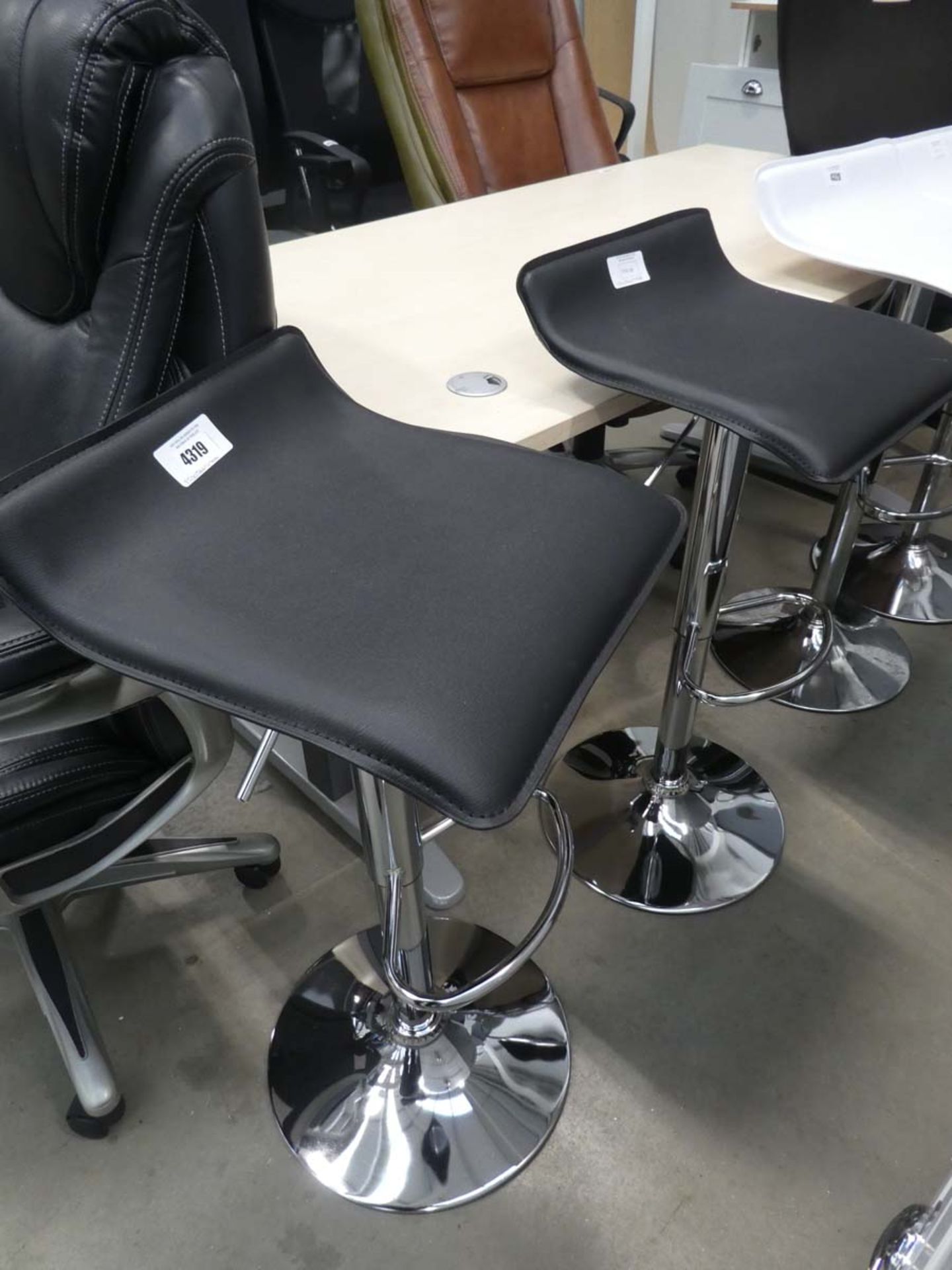 2 black chrome based bar stools