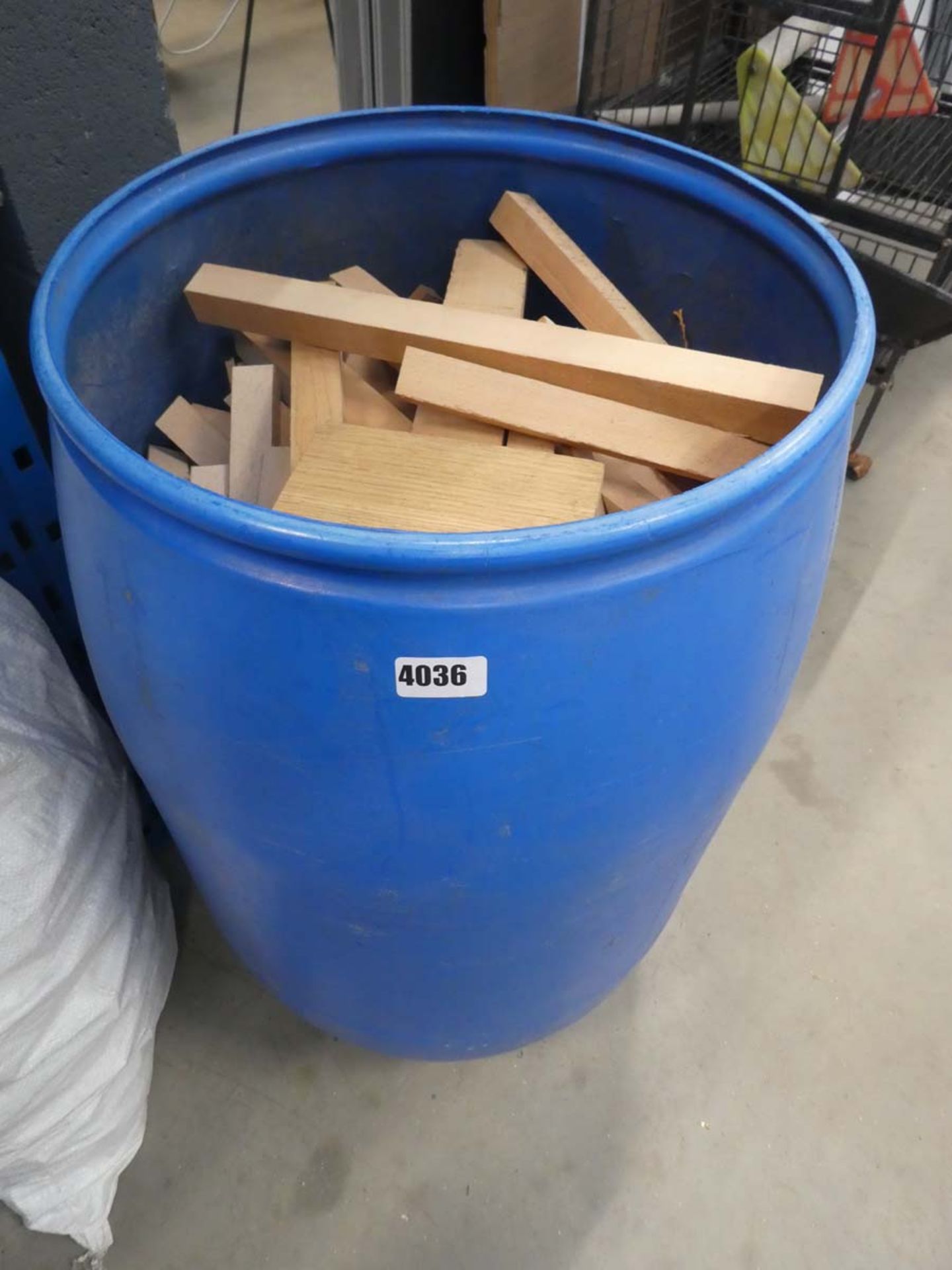 4 bags and a large blue water butt type container of wooden offcuts