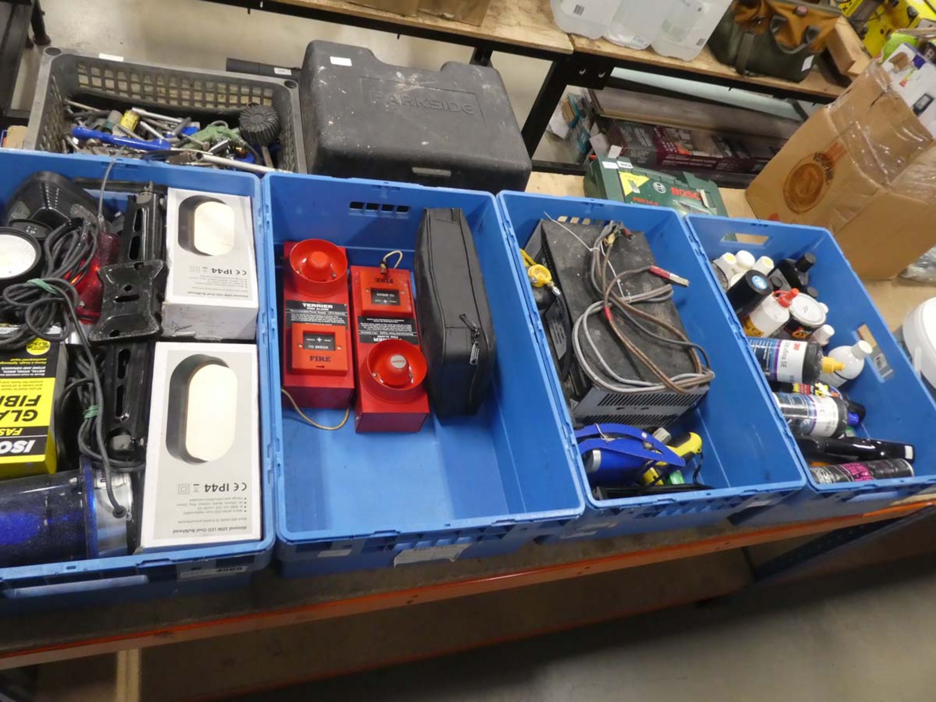 4 blue crates containing lights, jacks, fibreglass kit, fire alarms, battery charger and car