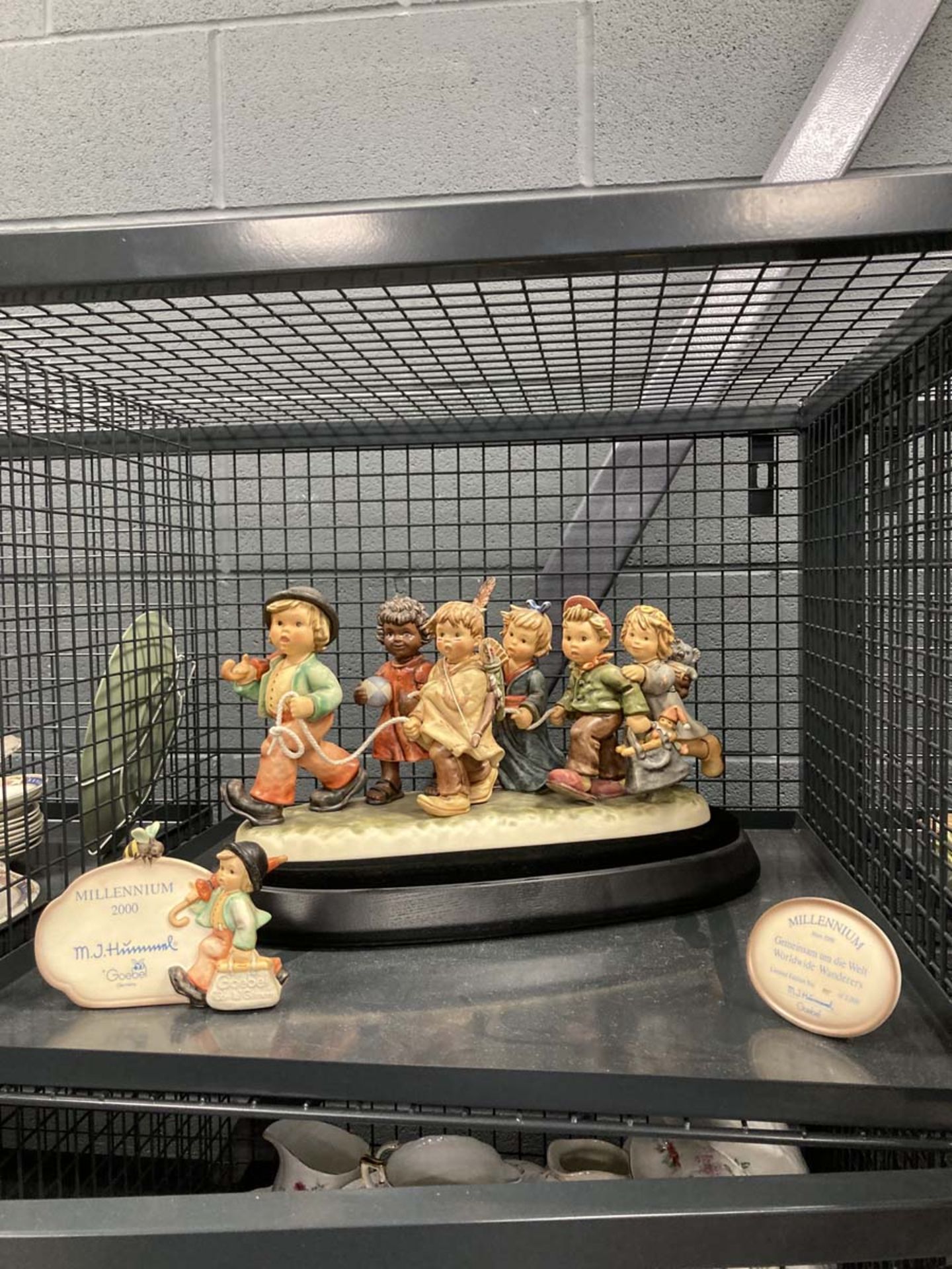 Cage containing Millennium Hummel figure entitled, 'Worldwide Wonderers' with stand and box