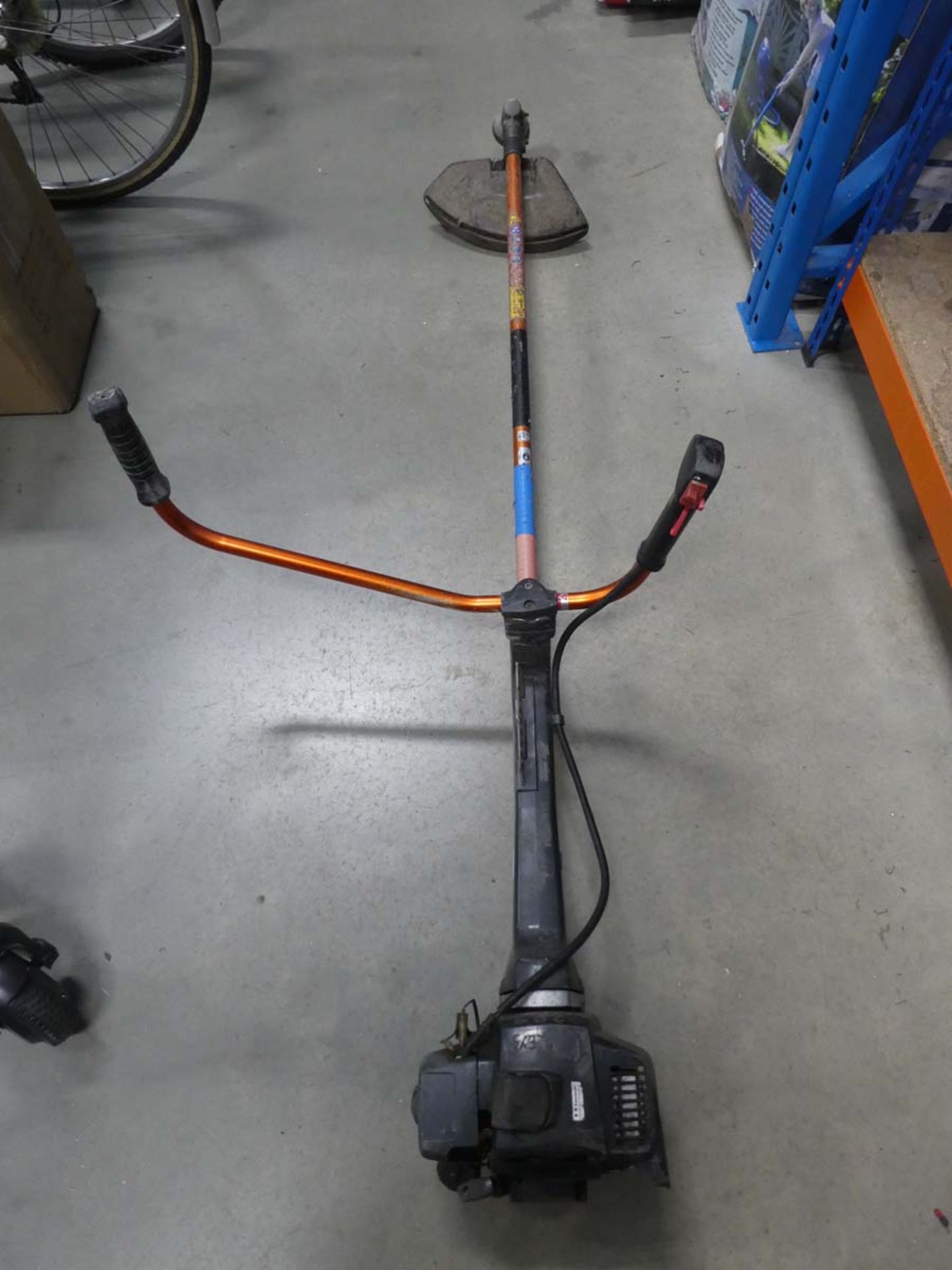 Black petrol powered double handed strimmer