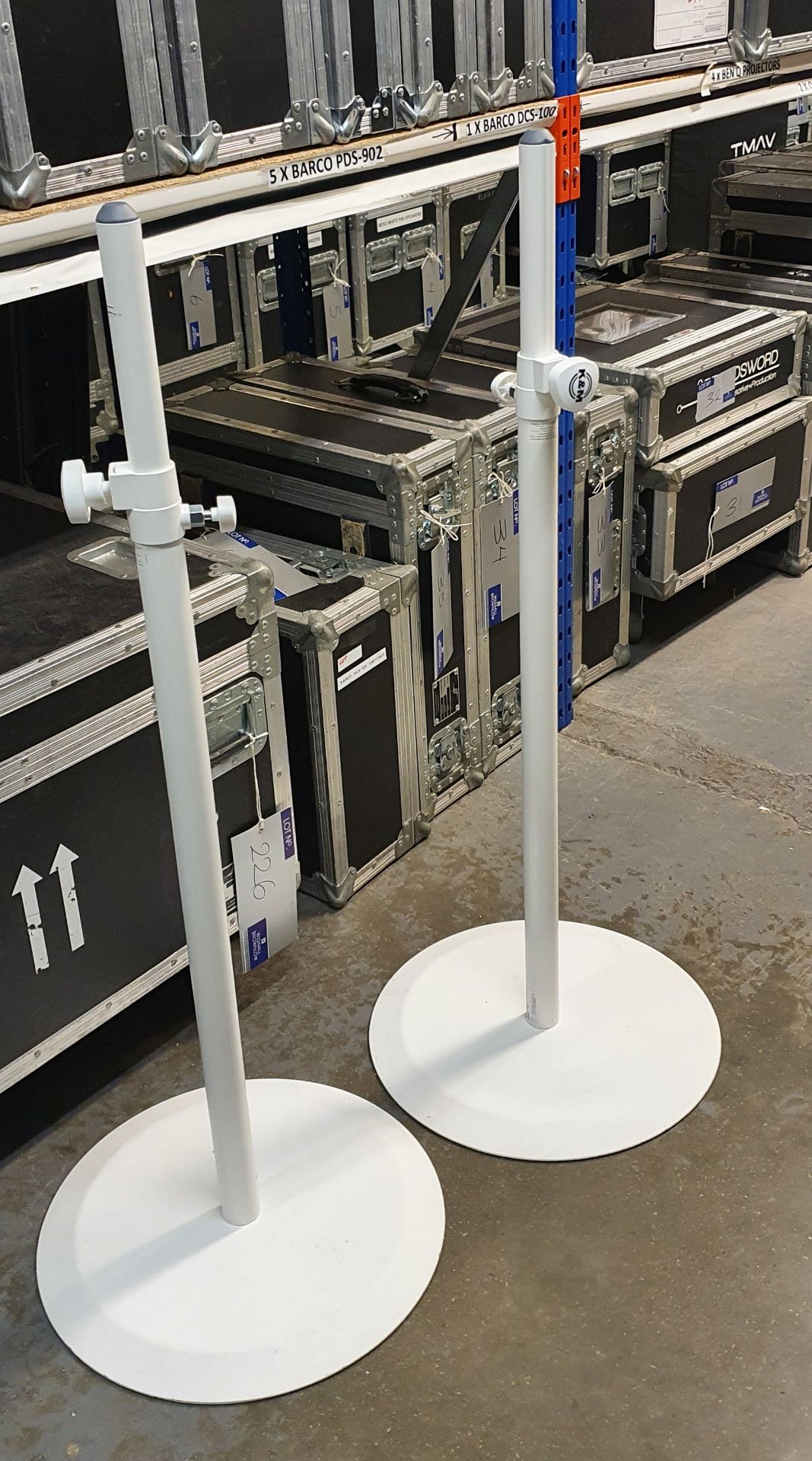 A Pair of K+M White Speaker Round Base Stands comprising: 2 poles and 2 bases with carry bags.