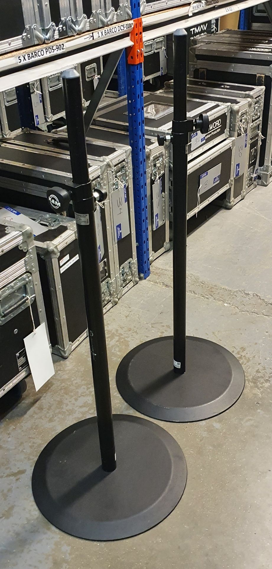 A Pair of K+M Black Speaker Round Base Stands comprising: 2 poles and 2 bases with carry bags.