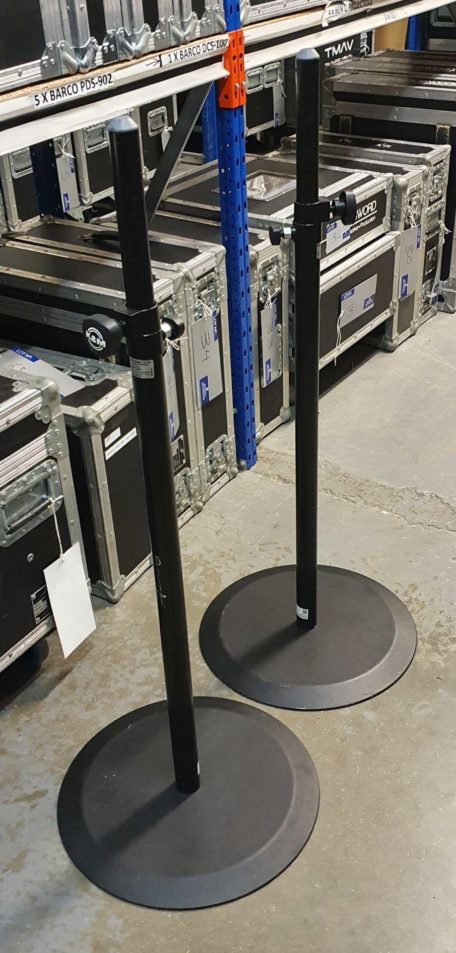 A Pair of K+M Black Speaker Round Base Stands comprising: 2 poles and 2 bases with carry bags.