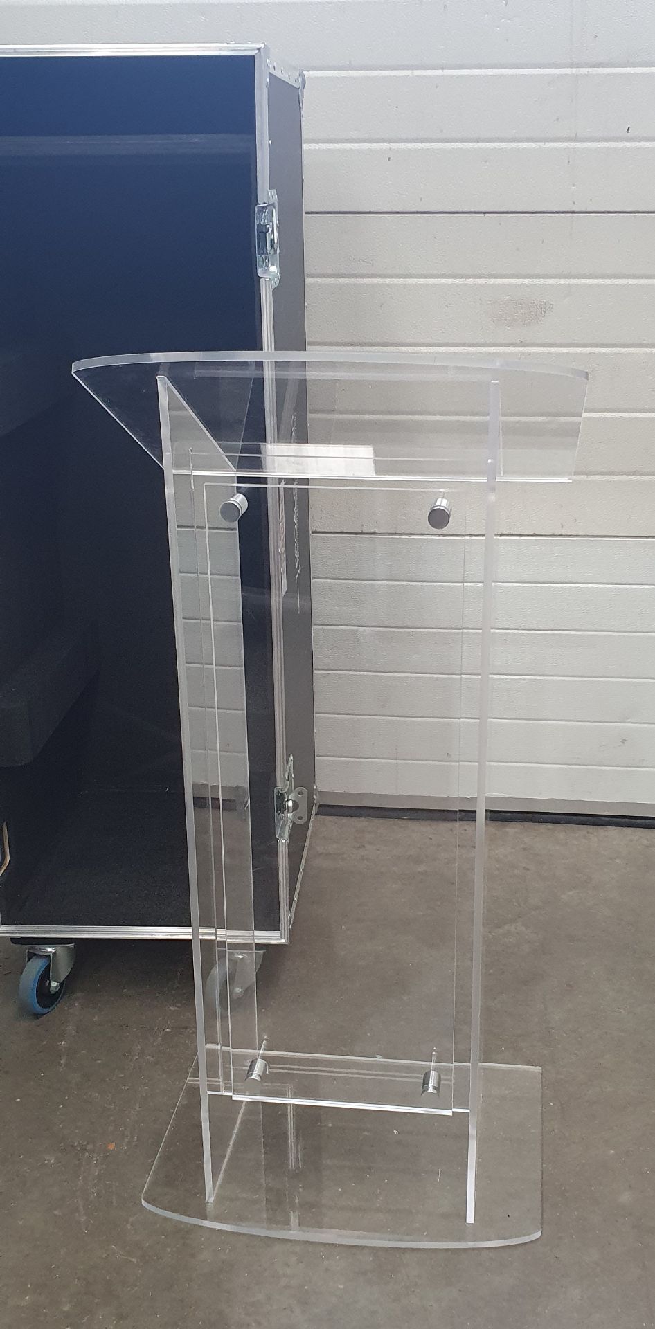 A Perspex Lectern with mobile flight case, 510mm x 620mm x 1350mm.