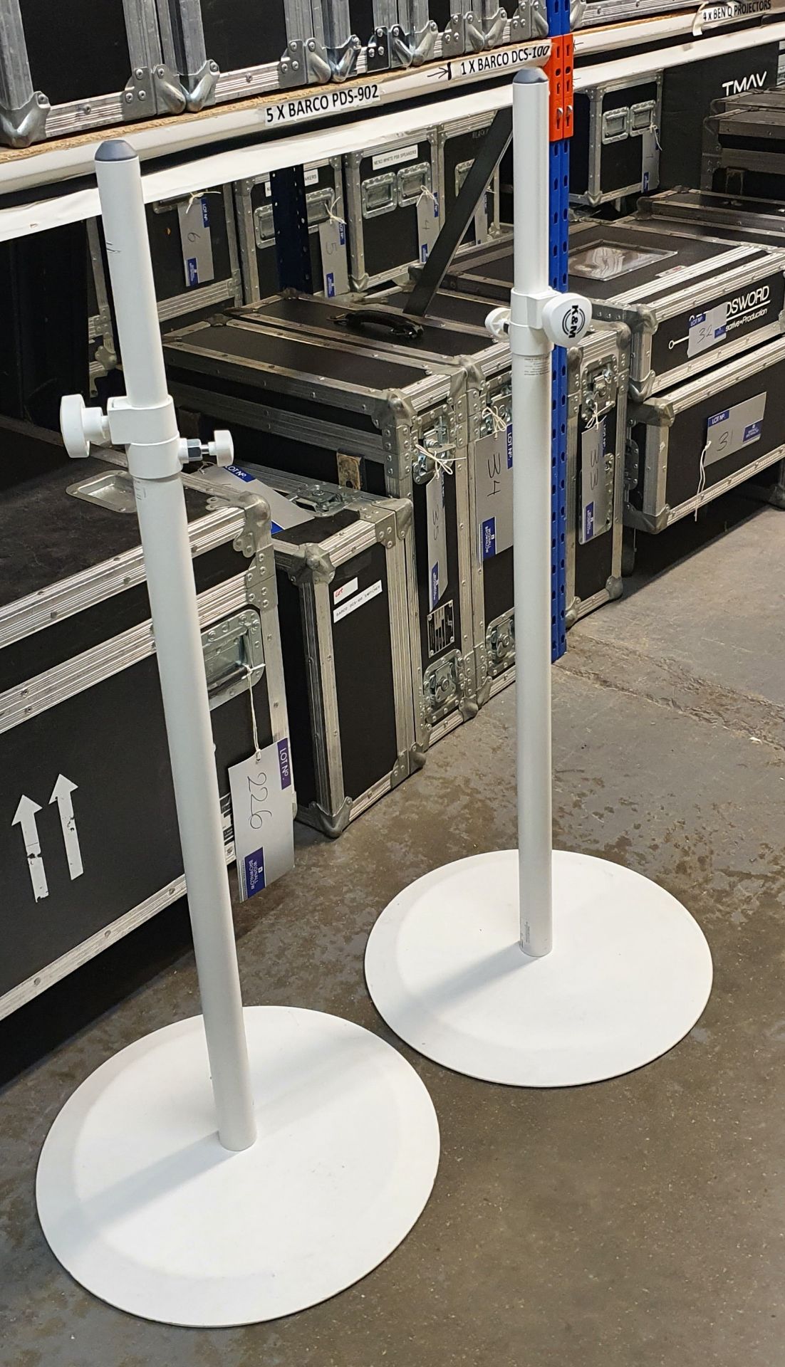 A Pair of K+M White Speaker Round Base Stands comprising: 2 poles and 2 bases with carry bags.